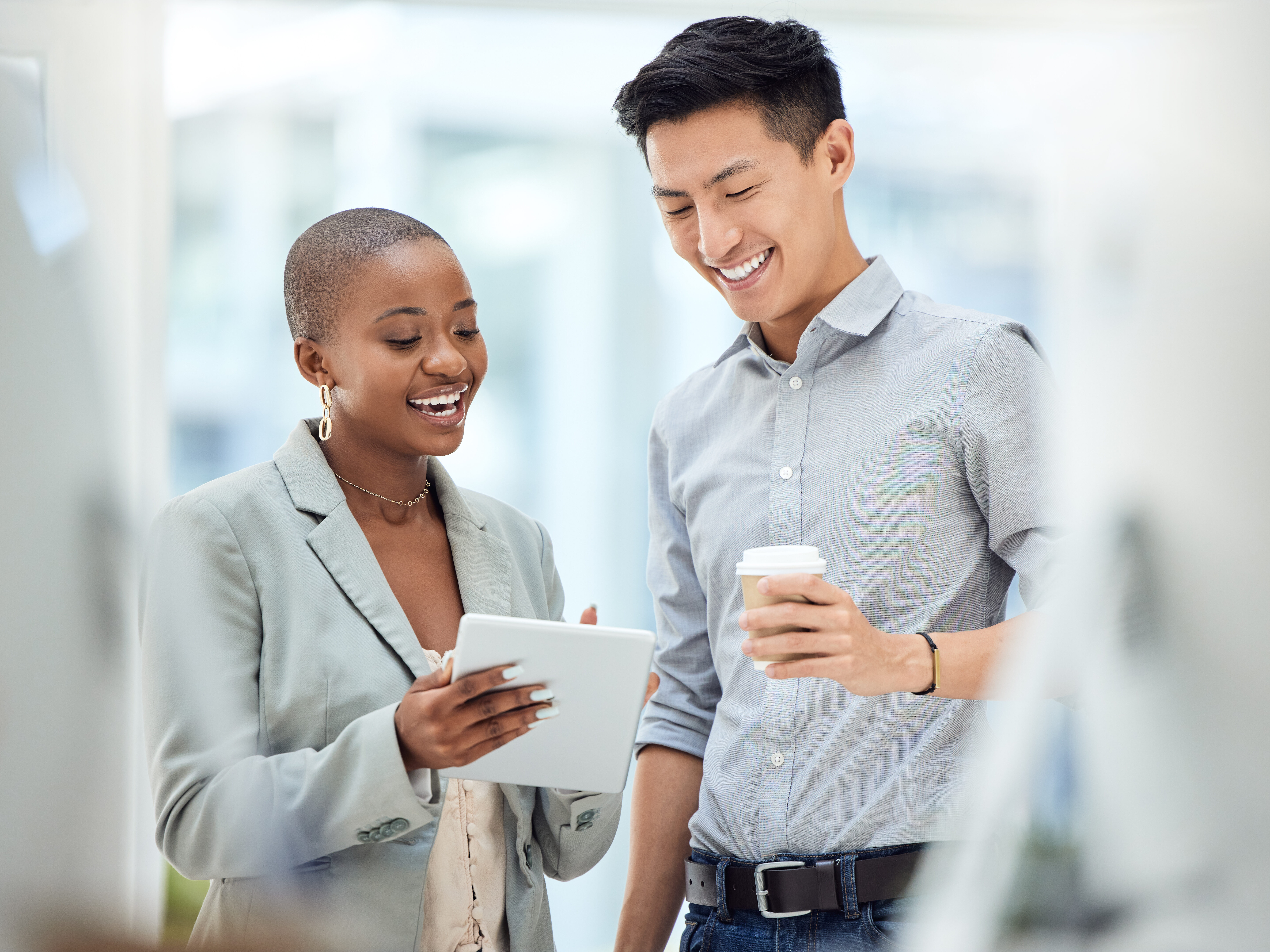 Tablet, smile and employees talking about business on the internet, online partnership and reading an email together at work. Marketing workers with idea for creative collaboration on technology